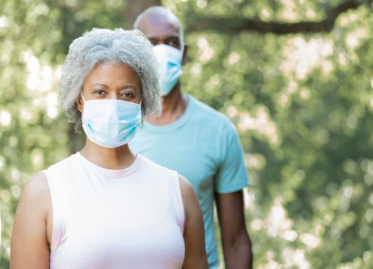 Woman and man wearing masks