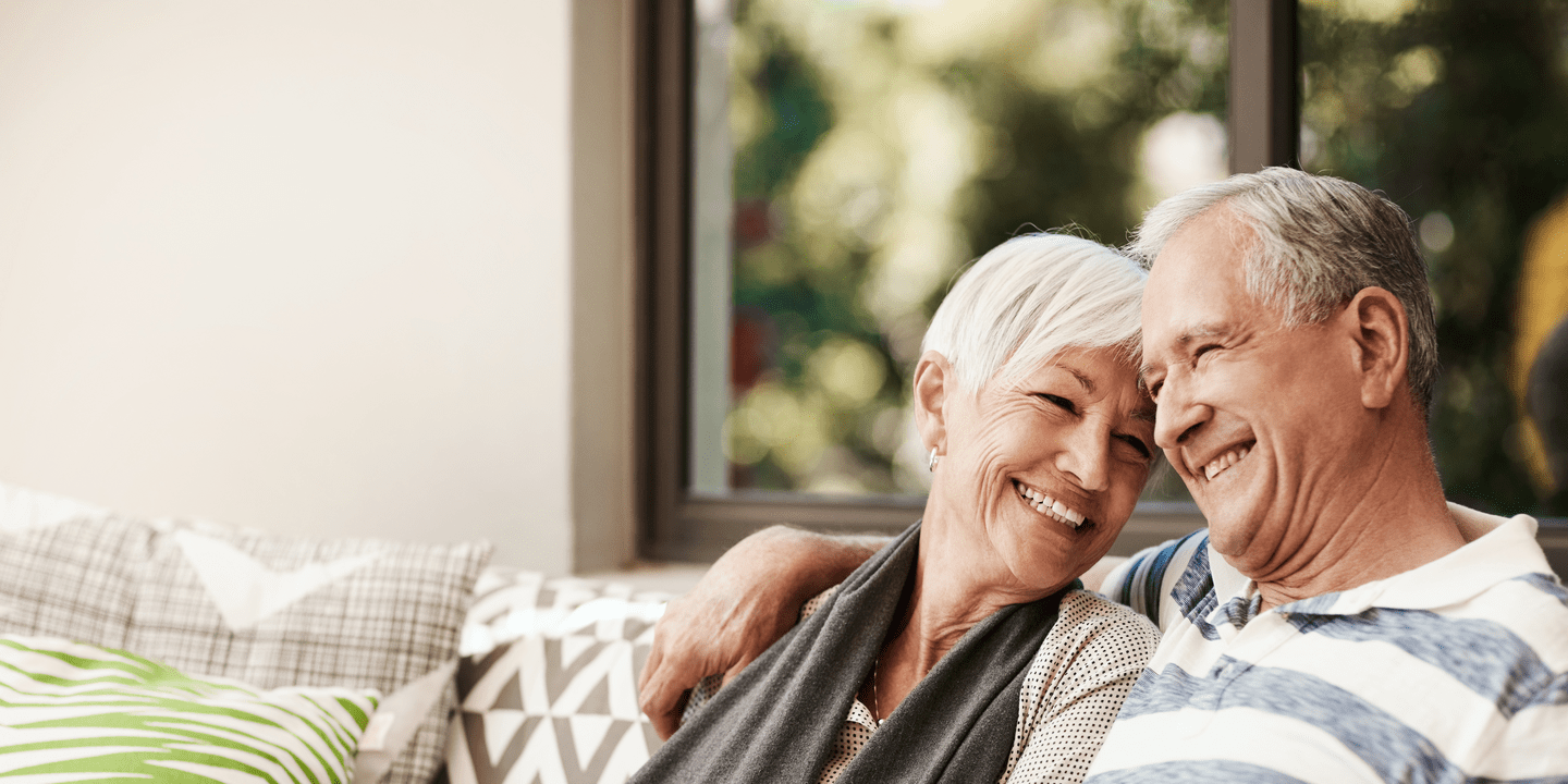Shot of a happy senior couple relaxing together on a sofa outside at home