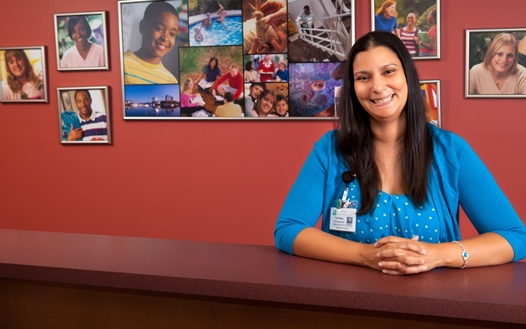 welcoming woman smiling at the front desk