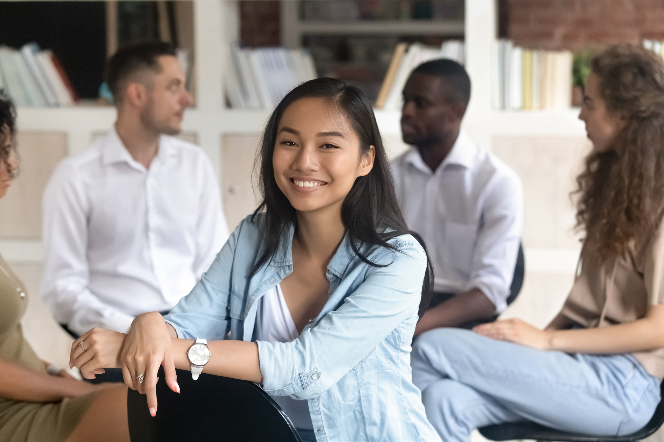 Teenager in diverse group smiling at the viewer