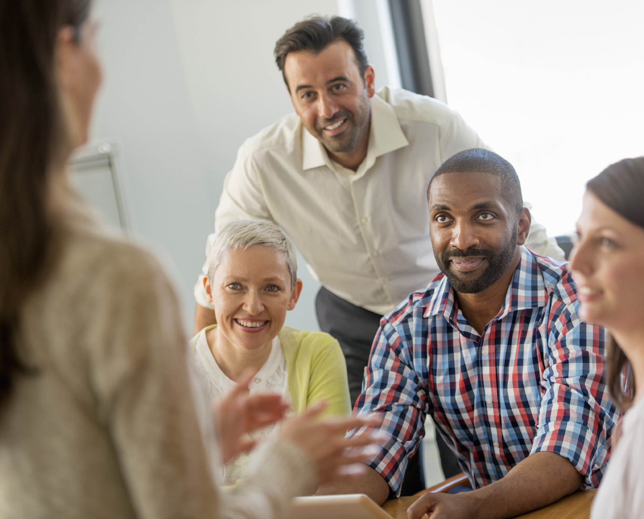 group of diverse people sitting in a meeting together