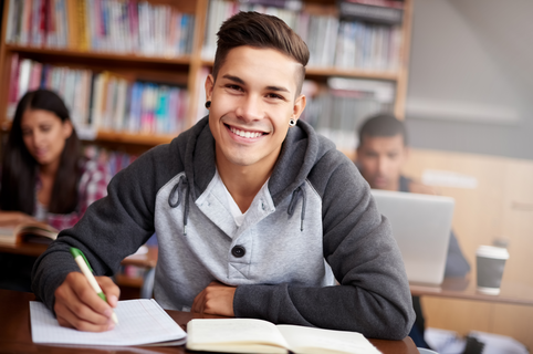  portrait of a handsome young student working diligently in his classroom