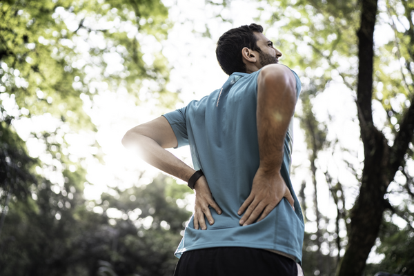 Sportsman feeling backache at a park