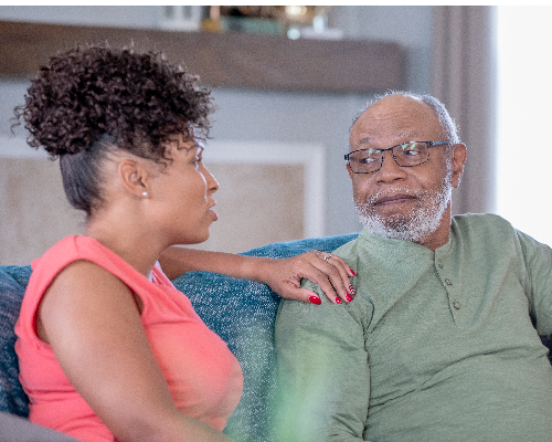 Woman visiting father in nursing home places her hand on his shoulder Neuro Spine Martha W. Goodson Center