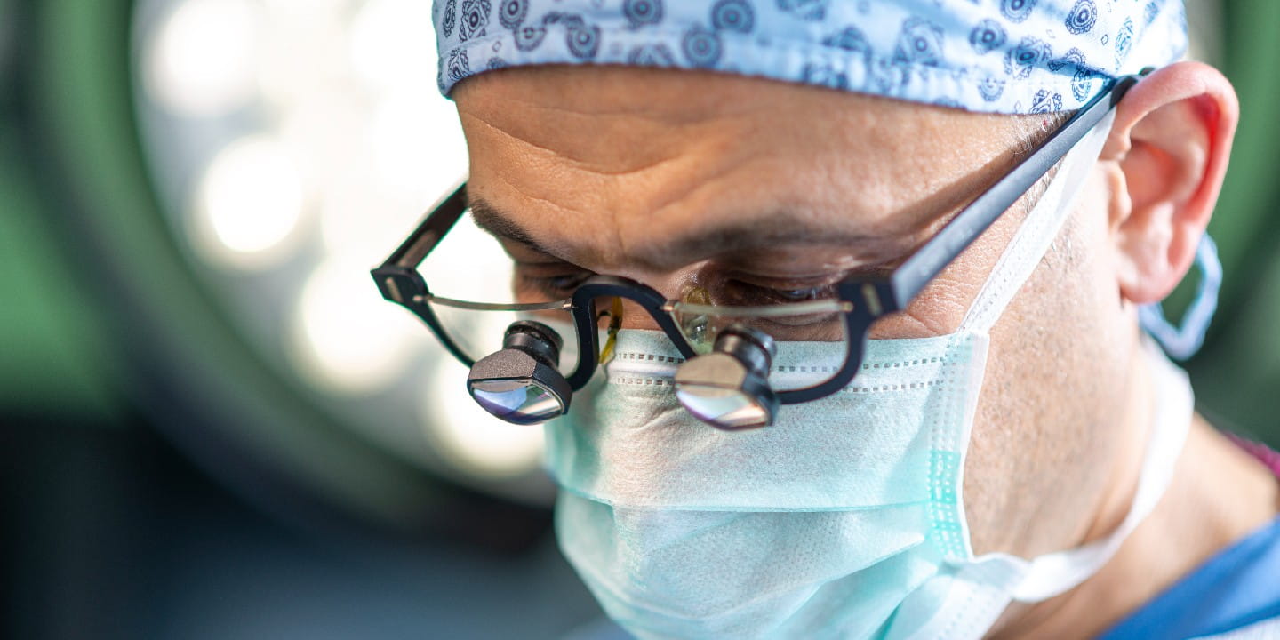 Close up face of surgeon man looking away with protective mask. 