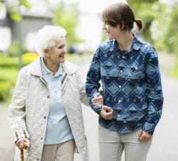 Older woman walking with young woman