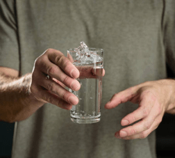 Man shacking glass of water