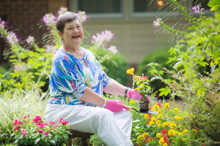 Ginger planting impatiens in her garden