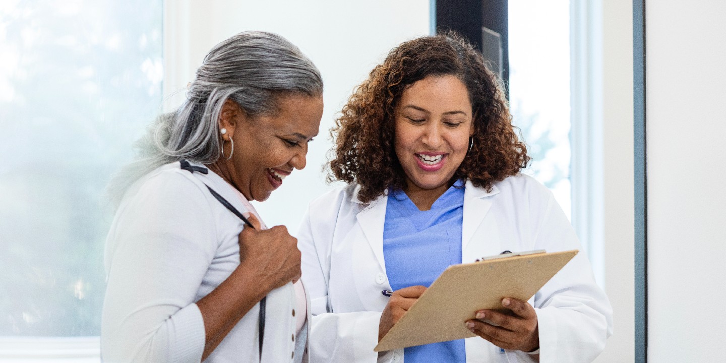 OrthoConnect Walk-in Clinic Female doctor and female patient smile while reviewing test resul