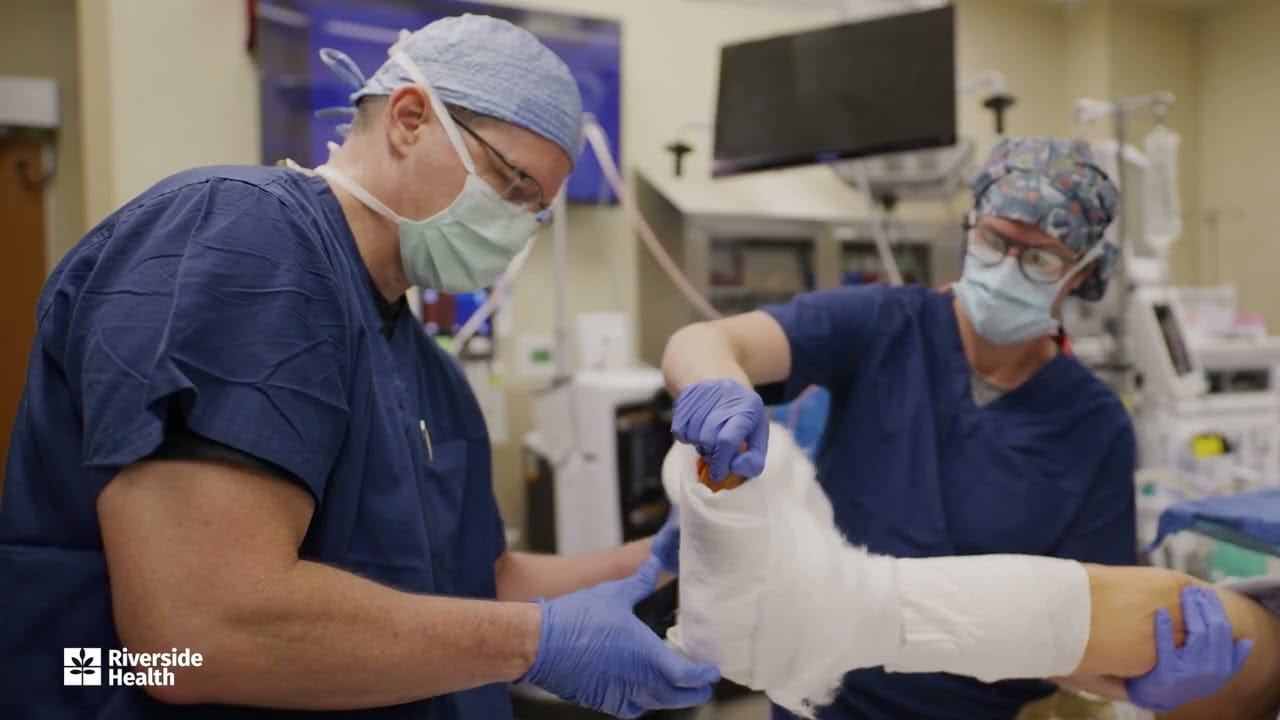 Dr. Jeffrey A. Levy and surgical team applying a cast during minimally invasive Achilles tendon repair at Riverside Health.