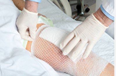 Doctor bandaging a wound