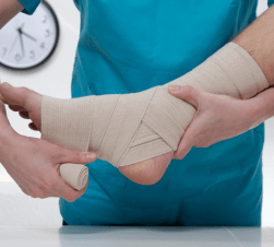 Nurse wrapping ankle bandage 