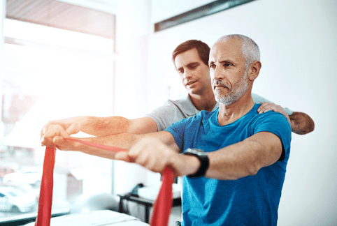 Men, physiotherapy and mature patient with resistance band for stretching for rehabilitation and support on injury. People, healthcare and help for wellness or wellbeing at clinic for trust and care 