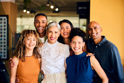 Cheerful business colleagues smiling towards camera at work