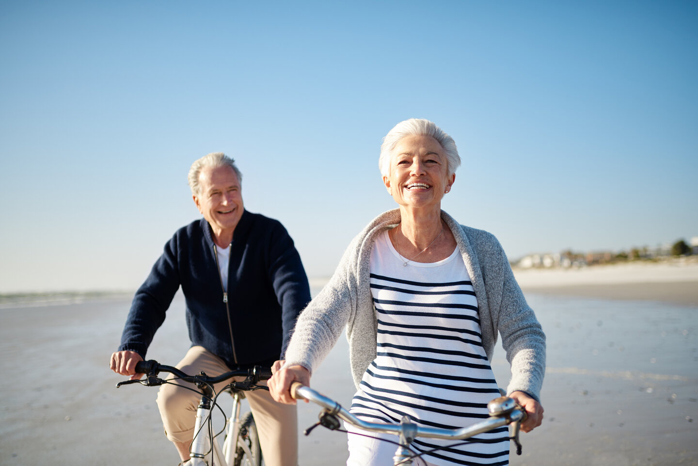 Shot of a senior married couple riding their bicycles on the beach