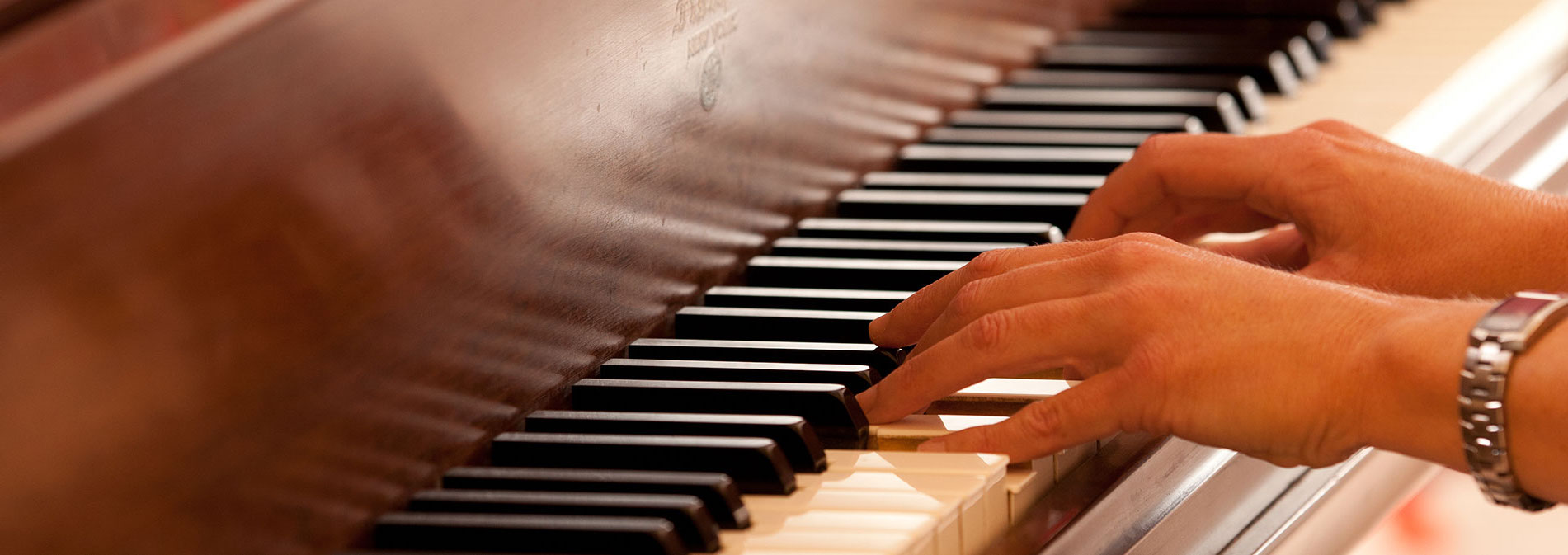 hands playing piano keys