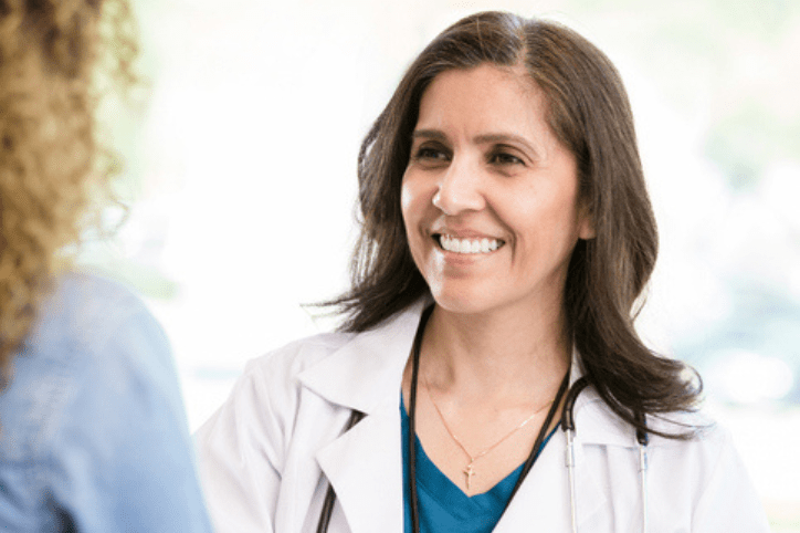 Gynecologists Confident female doctor greets female patient
