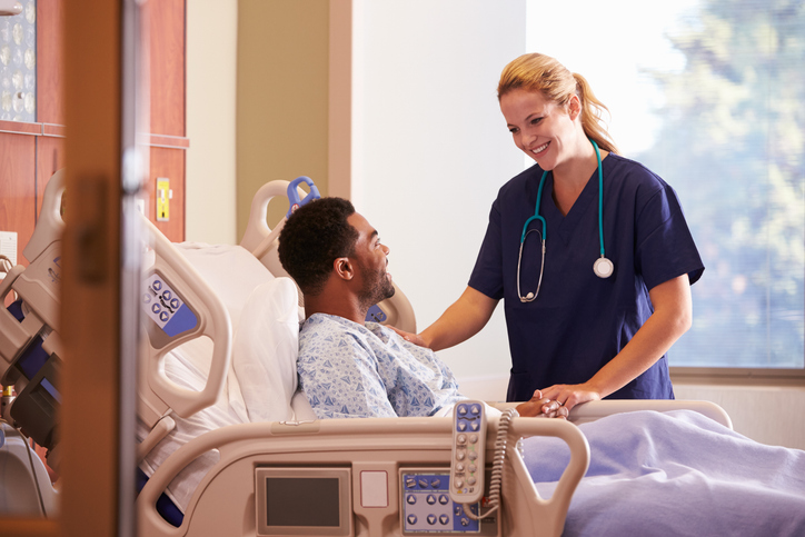 nurse talking to a male patient