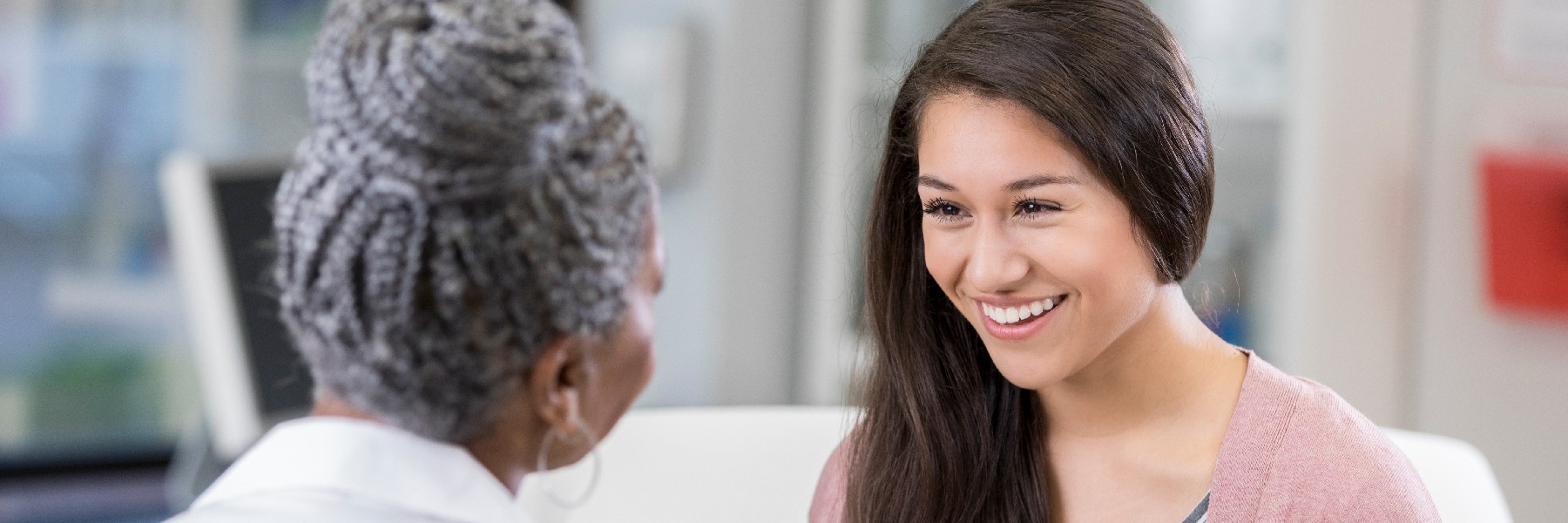 Primary Care Hereditary Personalized Care Cheerful patient talking with female doctor 