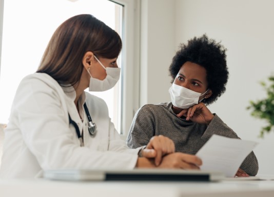 Health care worker talks with patient