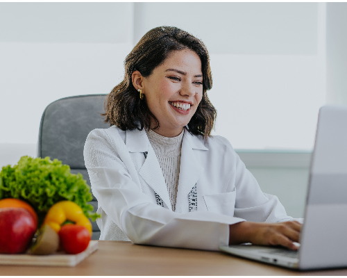Portrait of a nutritionist doctor working on the laptop 