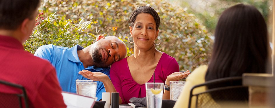 man asleep on wife's shoulder