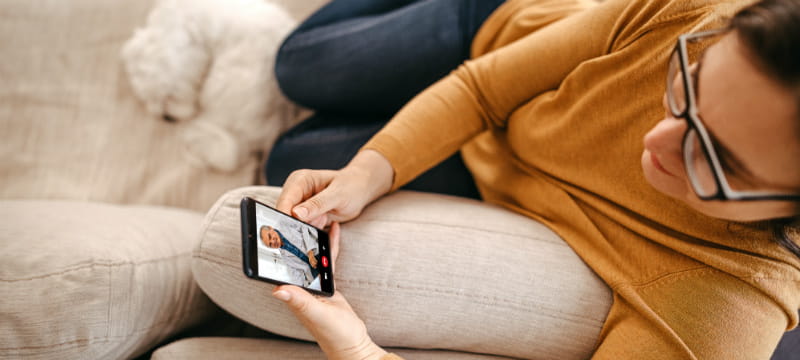 woman on video visit with smartphone