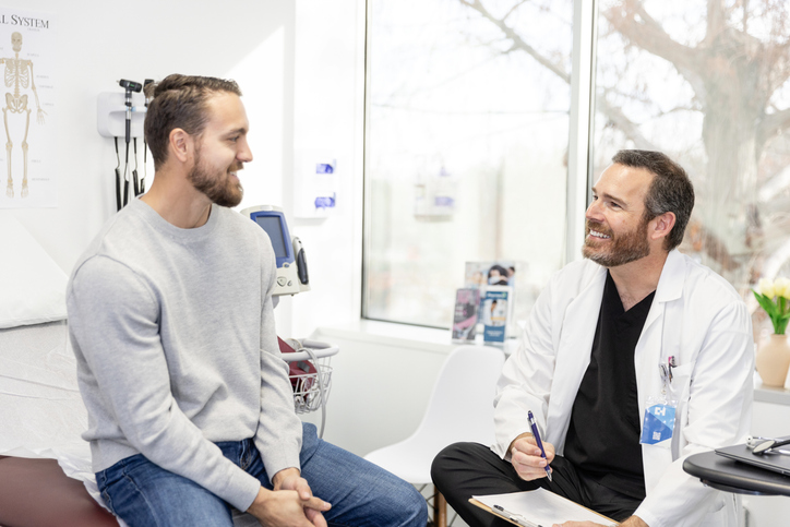 male doctor smiling at male patient