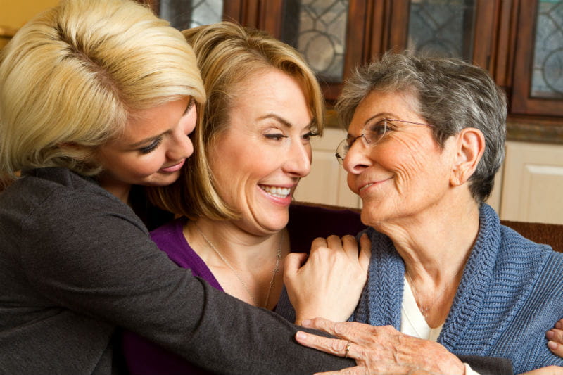 Three generations of women embrace