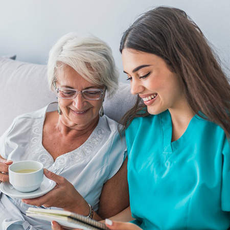 Senior woman and healthcare worker reading together