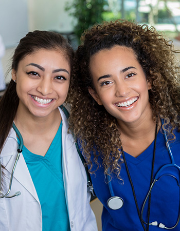 Two smiling staff members