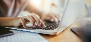 hand typing on a keyboard