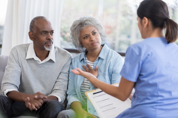 Doctor discusses health concerns with senior couple