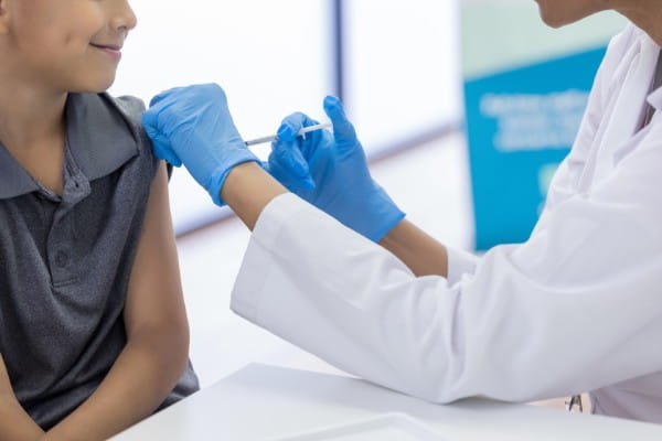 young boy getting vaccine