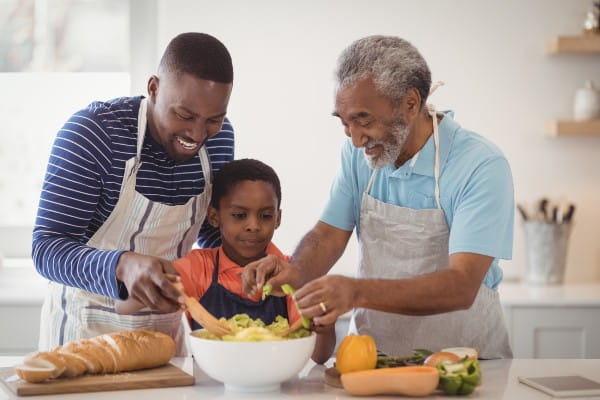 Multi-generation family preparing food in kitchen