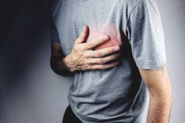 man holding hand over heart
