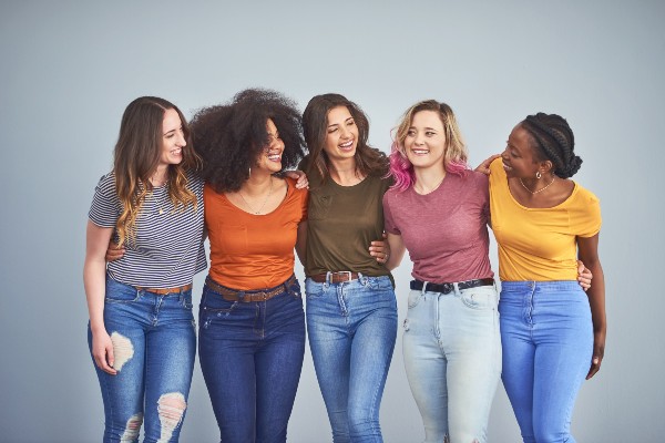 shot of a group of  young women embracing
