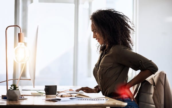 Shot of a businesswoman suffering from back pain