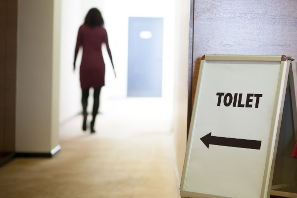 woman walking down the hall to the bathroom 