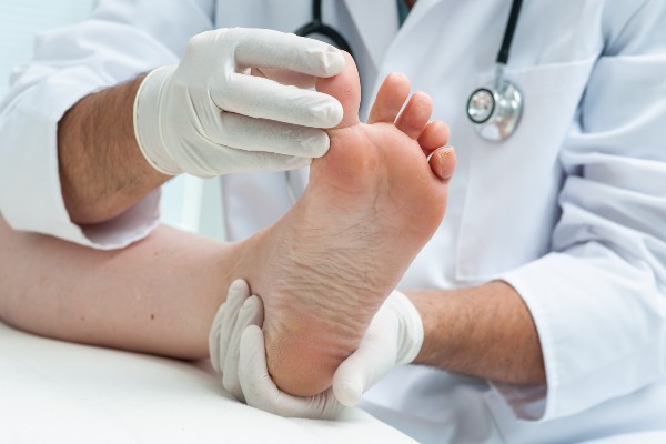 Doctor dermatologist examines the foot