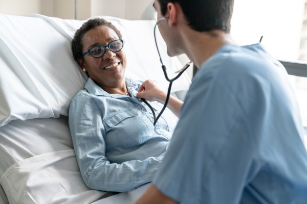 physician checking patient heartbeat