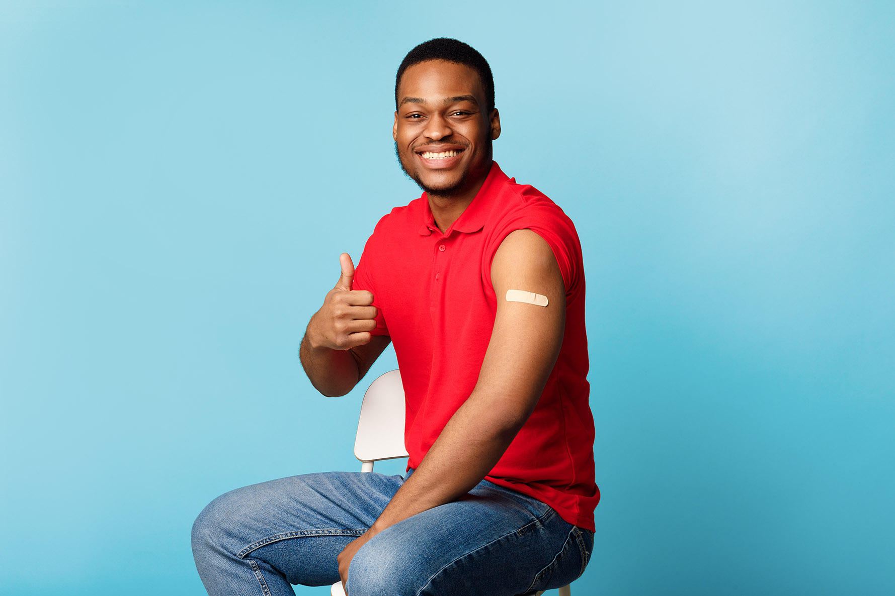 Man Smiling with a thumbs up after receiving a vaccine