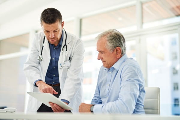 shot of a focused middle aged doctor talking with a patient