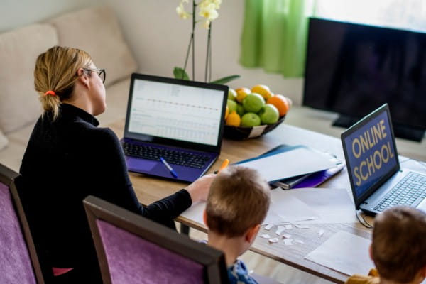 Mother working from home with young children in quarantine