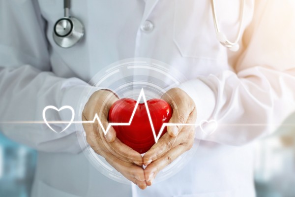 Doctor with stethoscope and red heart shape with icon heartbeat