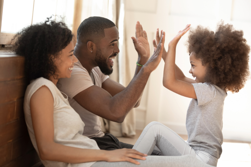 a photo of a family giving hi-fives to each other