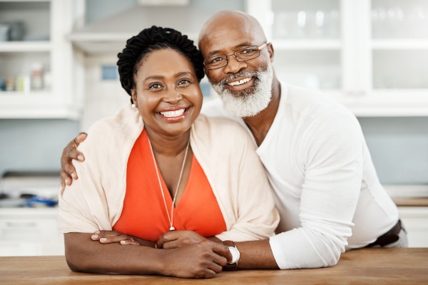 Older African American couple smiling at camera
