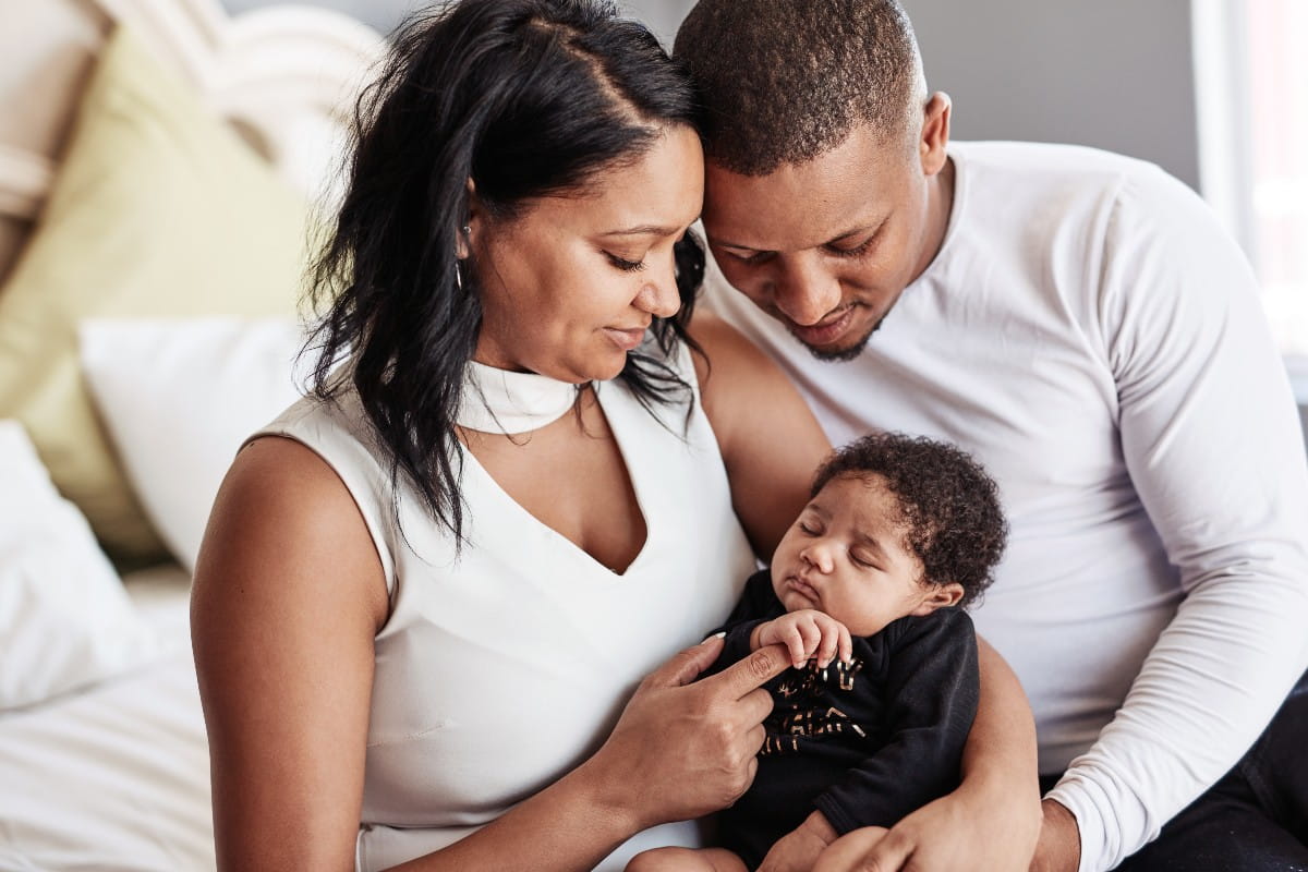 Couple holding newborn