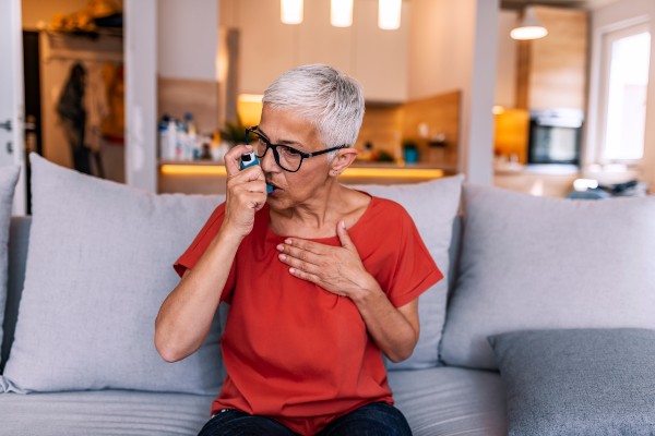 Asthmatic woman using an inhaler