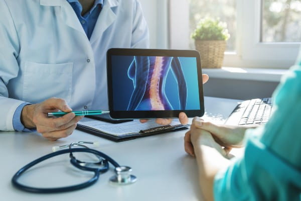 doctor showing patient disc image on computer